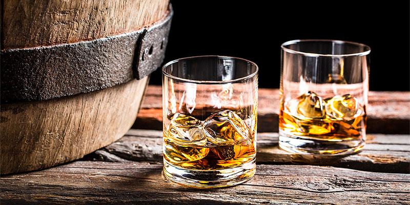 Whiskey glasses on barrel